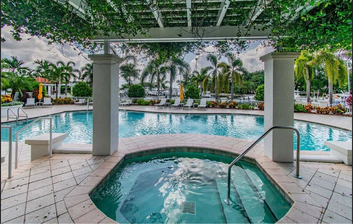 Community spa and pool beneath a columned pergola