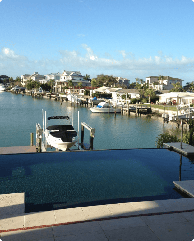 Waterfront Curtis Pools swimming pool overlooking a Florida canal