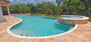 Pool with a spa and waterfall feature